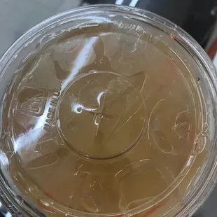 a close up of a plastic cup with a drink in it