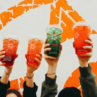 a group of people holding up drinks