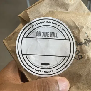 a person holding a paper bag