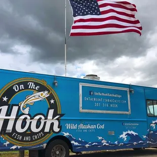 a blue food truck with an american flag
