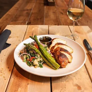 a plate of food and a glass of wine