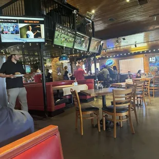 A server coming out of the kitchen to the dining area