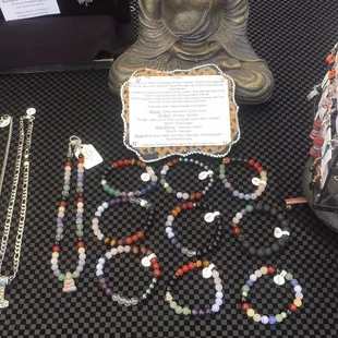 a buddha statue, beads, and necklaces