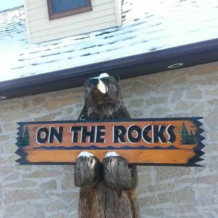 a bear holding a sign