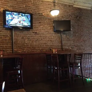 a tv mounted on a brick wall
