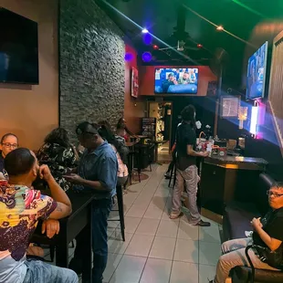a group of people sitting at a bar