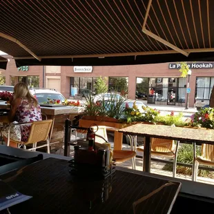 two women sitting at a table outside