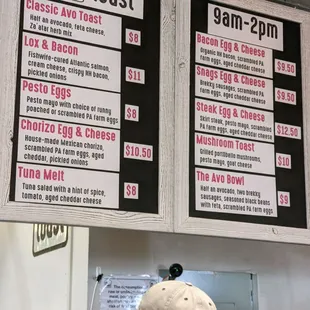 a man in a baseball cap looking at a menu