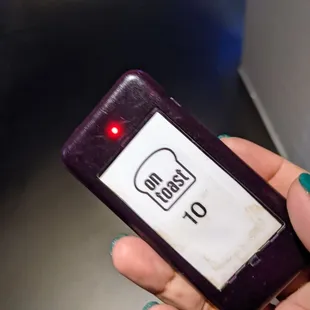 a hand holding a purple cell phone