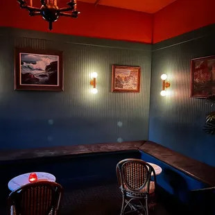 two chairs and a table in a room with a chandelier