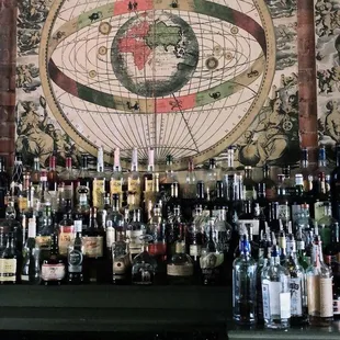 a map of the world on a wall behind a bar