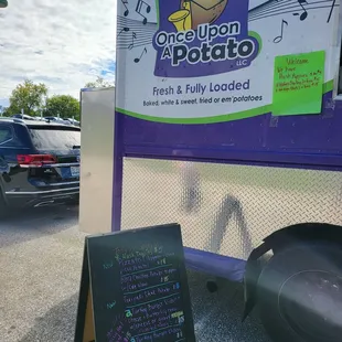 a sign next to a food truck