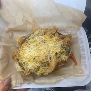 a person holding a container of food