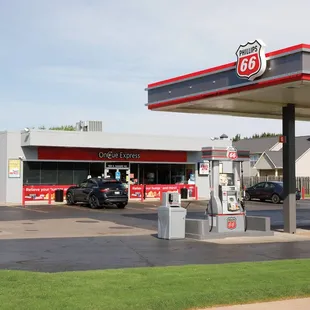 a gas station with cars parked in front of it