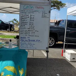 a table with a menu under a tent