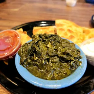 a plate of greens and dips