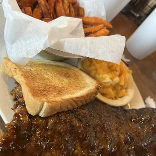 Ribs wet with sweet potato fries and Mac and Cheese