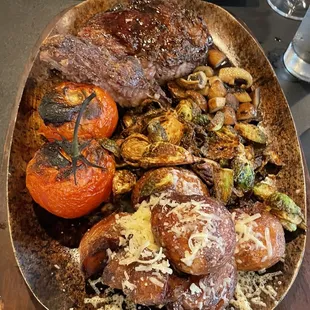 Ribeye for two- with tomatoes on the vine, brussels, mushrooms, and Parmesan potatoes