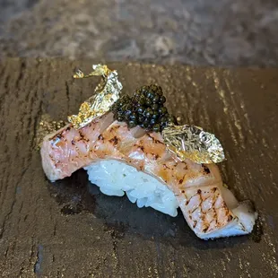 Salmon with gold leaf and caviar