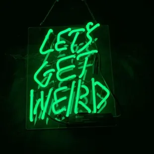 a neon sign that reads let&apos;s get weird