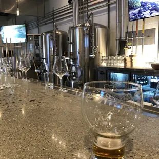 a glass of beer on a bar