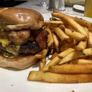 Black Angus Beef Burger w/double cut bacon, onion jam, aged cheddar, spicy aioli, pickles, served with garlic fries #doit