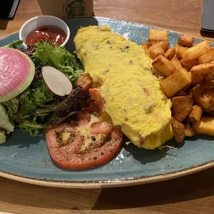 Breakfast of champions! Omelet of the Day with home fries and a delicious salad with a house made cherry vinaigrette