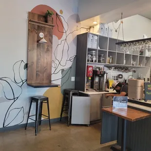 a coffee shop with a mural on the wall