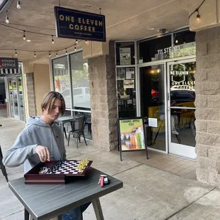 The outdoor seating and game of chess.