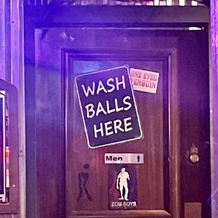 a bathroom door with a sign that says wash balls here
