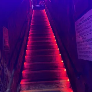 a staircase lit up with red lights
