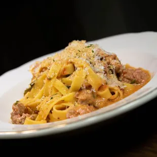 a plate of pasta with meat and cheese