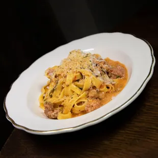 a plate of pasta with meat and cheese
