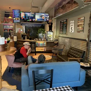 a man and a woman sitting on a couch in a restaurant