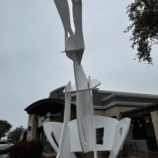a sculpture in front of a building
