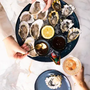 a plate of oysters and a glass of wine