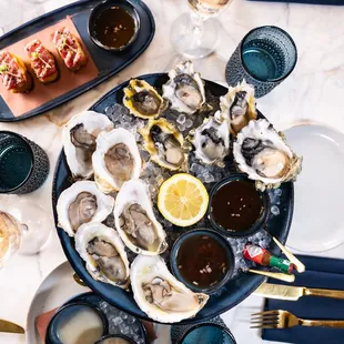 a platter of oysters and a glass of champagne