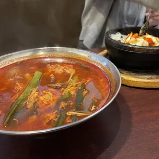 a bowl of soup and a pan of food