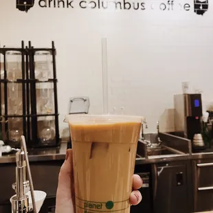 a hand holding a cup of coffee