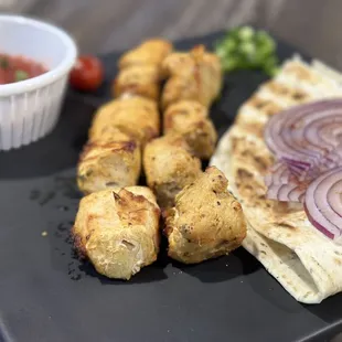 a plate of food and a bowl of sauce