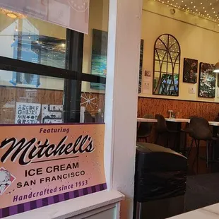 Local art and theatre (and icecream!) promoted on two walls as viewed from alcove by the vestibule