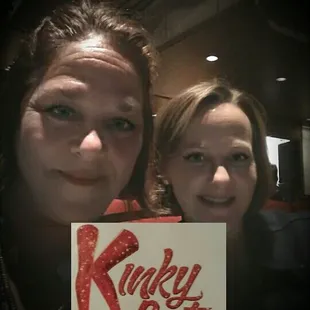 a woman and a woman holding a sign