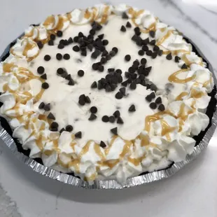 a pie topped with whipped cream and chocolate chips