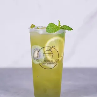 a glass of iced tea with a mint leaf garnish