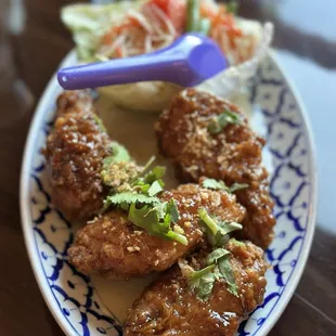 Thai fried chicken served with papaya salad
