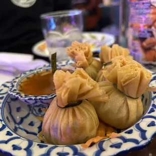 a plate of dumplings and sauce