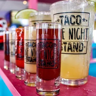 a row of taco drinks