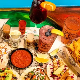 a variety of tacos and drinks
