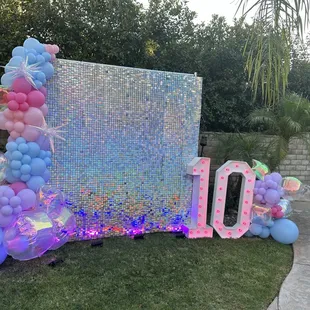 Eras tour inspired party theme with sequin rainbow backdrop