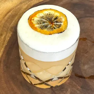 a drink with a slice of orange on top